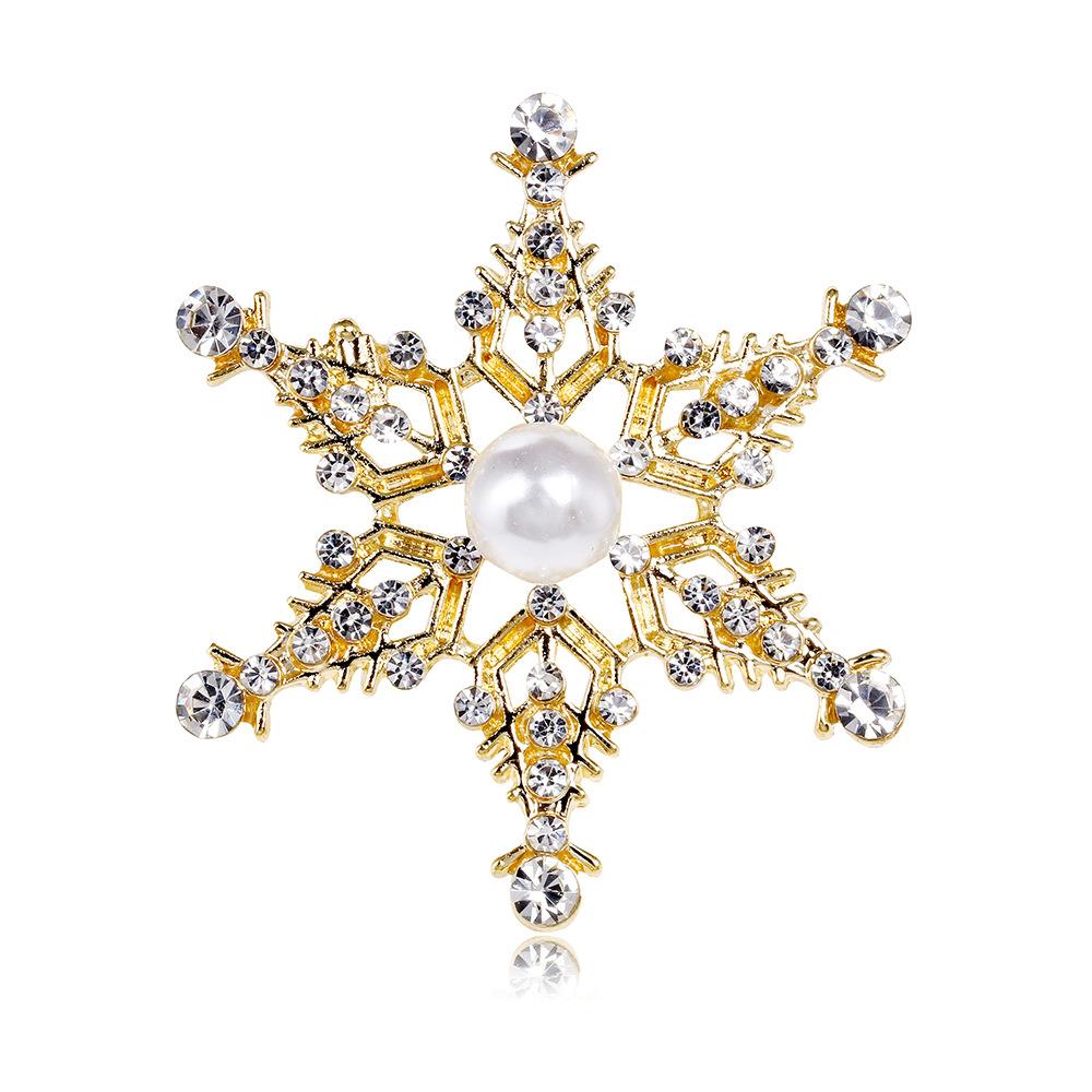 Crystal open detail snowflake brooch in gold